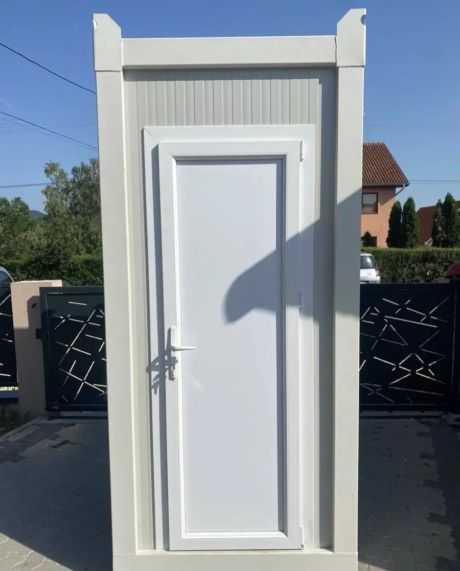 White single flushing restroom cabin standing on pavers